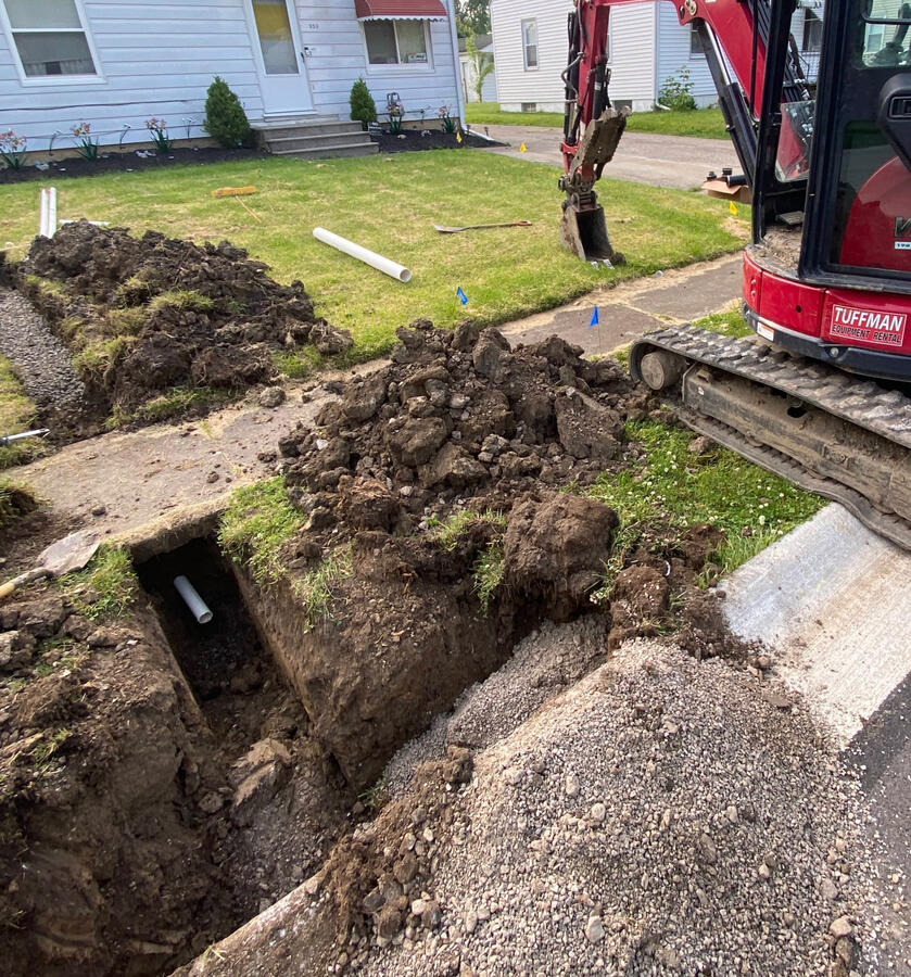 Sump pump line tie-in without disturbing the sidewalk. Smart digging keeps costs down and results clean—just one way we look out for our customers.